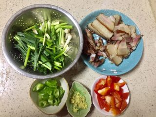 香蒜苗腊肉~年味美食,煮腊肉的时候把蒜苗洗净后切段，径和叶要分开放，青椒和红椒切小块，老姜切姜米，腊肉如有单独的瘦肉和大块肉分开放